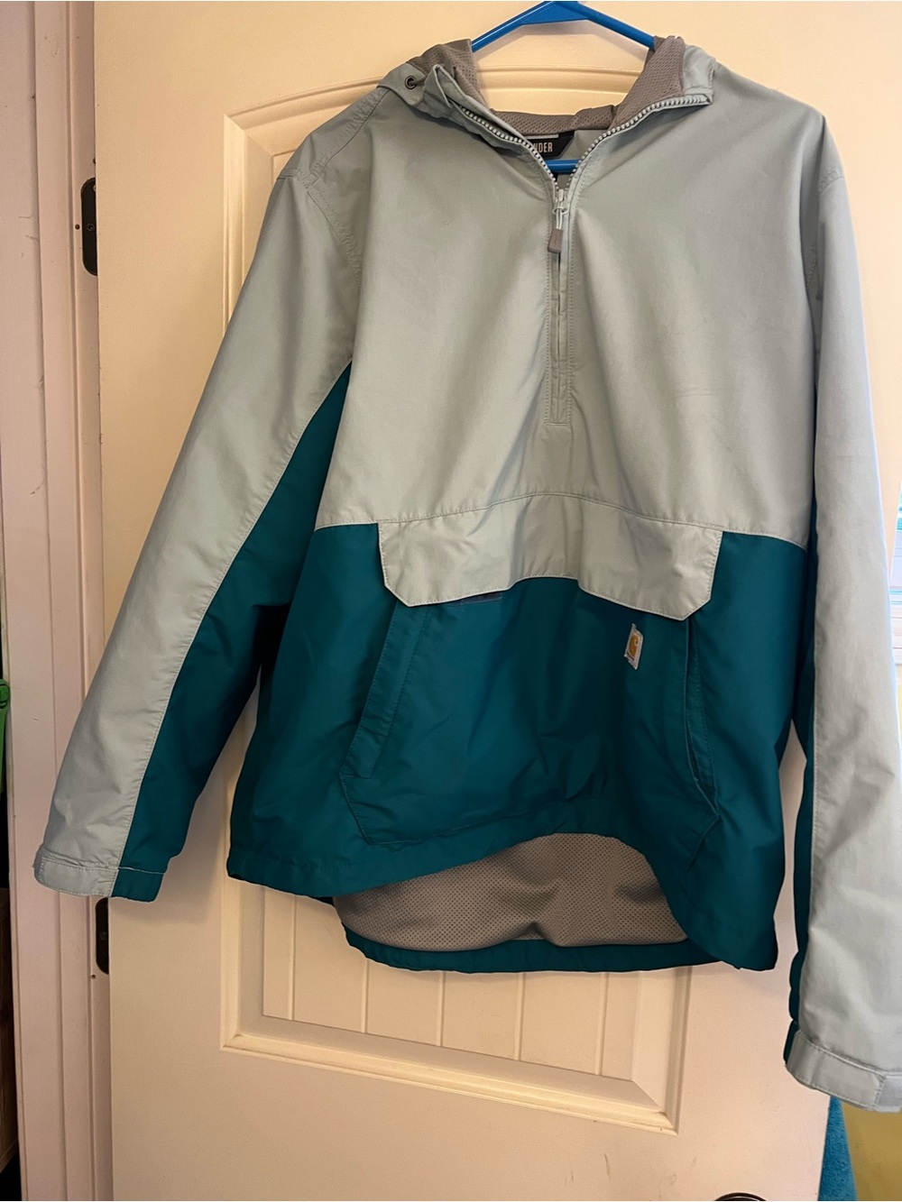 Carhartt Rain Defender anorak in light green and teal.